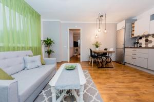 a living room with a couch and a table at Cozy beach apartment in Pärnu