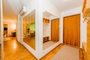 a hallway with sliding glass doors and a living room at Cozy beach apartment in Pärnu