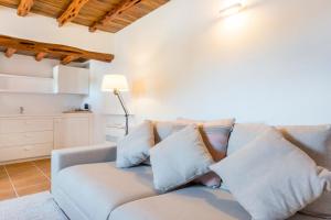 
a white couch with pillows and pillows in a room at Agroturismo Can Toni Xumeu - Adults Only in Cala Llonga
