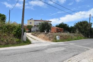an empty road with a house on a hill at Maison D'Almoinha in Sesimbra
