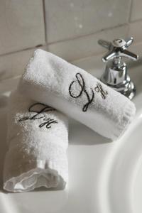 a white towel with the wordabuse written on it on a sink at Heritage Avenida Liberdade - Lisbon Heritage Collection - Avenida in Lisbon