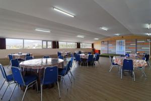 a banquet hall with tables and chairs at Hotel Bumi Makmur Indah in Bandung