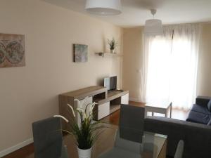 a living room with a couch and a table at Apartamento turisticos Puente Romano P4 1-A in Salamanca