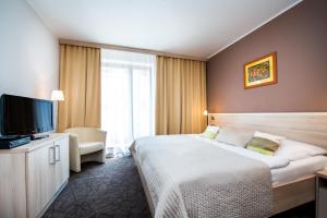 Uma cama ou camas num quarto em Hotel Mlynska