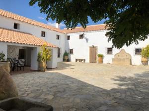 eine Terrasse vor einem weißen Gebäude in der Unterkunft Cortijo el Ciego in Alcalá la Real