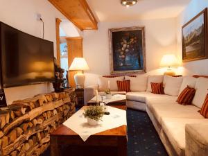 a living room with a couch and a tv at Hotel Berghof in Nauders
