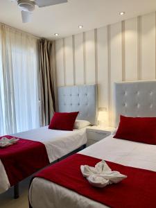 sypialnia z dwoma łóżkami z czerwonymi i białymi prześcieradłami w obiekcie Apartamentos Fuerteventura Sol w mieście Costa Calma +37 zdjęć