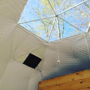 a ceiling of a white tent with a window at Blue Bayou Resort, Cape Breton in Dingwall
