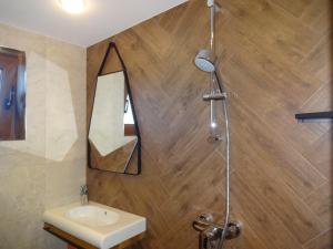 a bathroom with a sink and a mirror at Apartments Dona in Chernomorets +102 photos