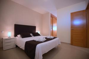Łóżko lub łóżka w pokoju w obiekcie Apartamentos Fuerteventura Sol