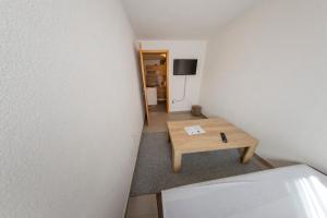a small room with a table and a tv at Apartment Resaa in Bihać