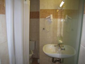 a bathroom with a sink and a toilet at Nafsika Hotel in Rhodes Town