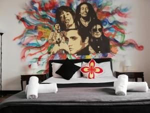 a bedroom with a mural of the beatles on the wall at Leone X Genova Affittacamere in Genoa