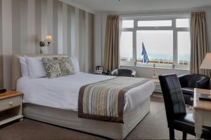 a hotel room with a bed and a window at Best Western Princes Marine Hotel in Brighton & Hove
