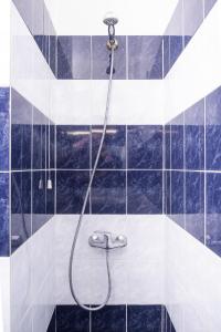 a shower stall with a glass shower curtain at Athens Odeon Hotel in Athens