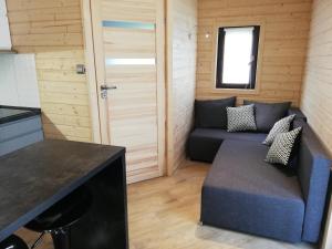 a small living room with a couch and a table at Domek nad morzem in Będzino