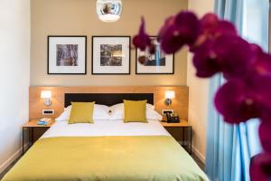 a bedroom with a bed and two tables with lamps at Boutique Villa Filaus in Dubrovnik