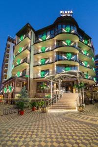 a large building with a staircase in front of it at Hotel Plaza in Anapa