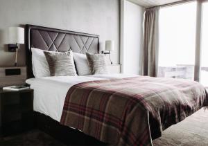 Postel nebo postele na pokoji v ubytování Langley Hôtel Tignes 2100