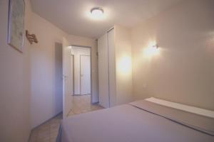 a bedroom with a bed and a hallway at Le Vallon des Sources in Digne-les-Bains