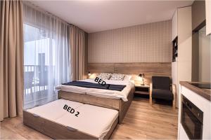 Posteľ alebo postele v izbe v ubytovaní Trio Tatry