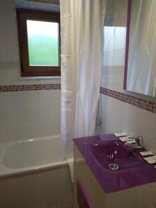 a bathroom with a purple sink and a bath tub at Casa de Aldea La Xunta in Cangas de Onís +8 photos