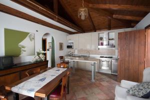 a kitchen with a table and a dining room at Agapantus Bed & Breakfast in Diamante
