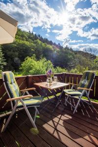 un patio con 2 sillas y una mesa en una terraza en Ferienwohnung Loft en Schmallenberg