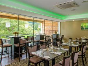 a restaurant with tables and chairs and a large window at The Kinmel & Kinspa in Abergele