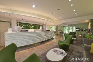 a lobby with green chairs and a hotel dive inn at Hotel Due Pini in Formigine