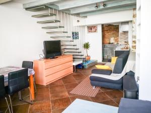 a living room with a staircase and a tv at Munroe Apartment in Dubrovnik