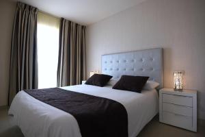 Łóżko lub łóżka w pokoju w obiekcie Apartamentos Fuerteventura Sol