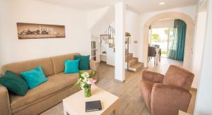 a living room filled with furniture and a couch at Aparthotel Ona Aucanada in Port d'Alcudia