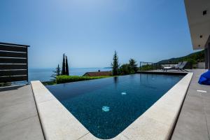 a swimming pool with a view of the ocean at Villa The View in Poljane