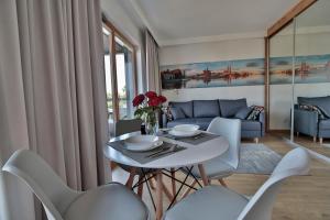 a living room with a white table and chairs at ApArt Bulwary Wrocław in Wrocław