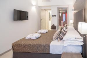 a bedroom with two beds and a flat screen tv at Wellness Home Rome in Rome +27 photos