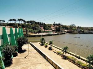 a body of water with palm trees next to a bridge at Recanto do Lago Triunfo in Triunfo
