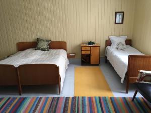 A bed or beds in a room at Skjeggestad Gjestehus