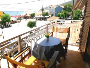 a table on a balcony with a view of the ocean at Marialena Pension in Ireon