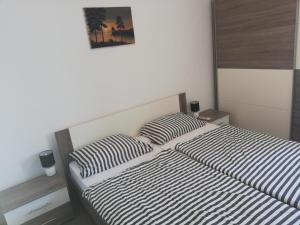 a bedroom with two beds and a picture on the wall at Stole Apartment in Izola