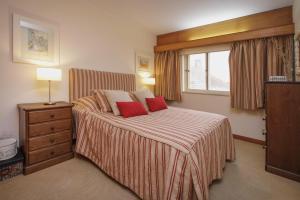 a bedroom with a bed with two red pillows at Labrax Viewpoint in Caminha