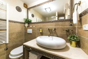 a bathroom with a sink and a toilet at Apartment Ave Caesar in Split