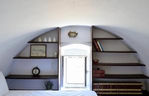a room with a staircase with shelves and a door at Drymonas Heights Kythira Traditional Volto in Kýthira