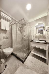 a bathroom with a toilet, sink, and shower at Albinas Hotel Old City in Istanbul