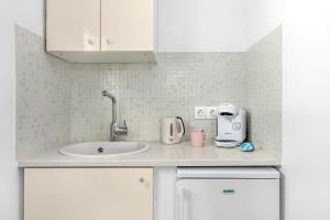 a kitchen counter with a sink and a mixer at Central Suites Mykonos in Mikonos