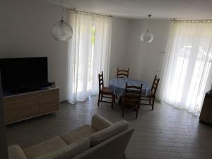 a living room with a couch and a table and a television at Levanto House in Levanto