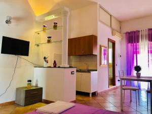 a kitchen with a refrigerator and a table at Carlottas'home in Catania