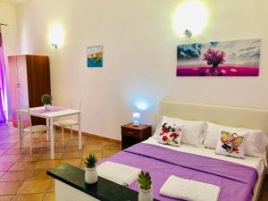 a small room with a bed and a table at Carlottas'home in Catania