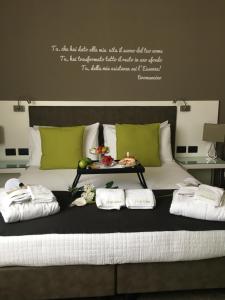 a bed with a tray of food on top of it at L`essenza B&B in Reggio di Calabria