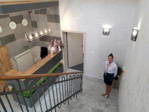 a woman standing in the hallway of a building at Villa Centro in Oświęcim